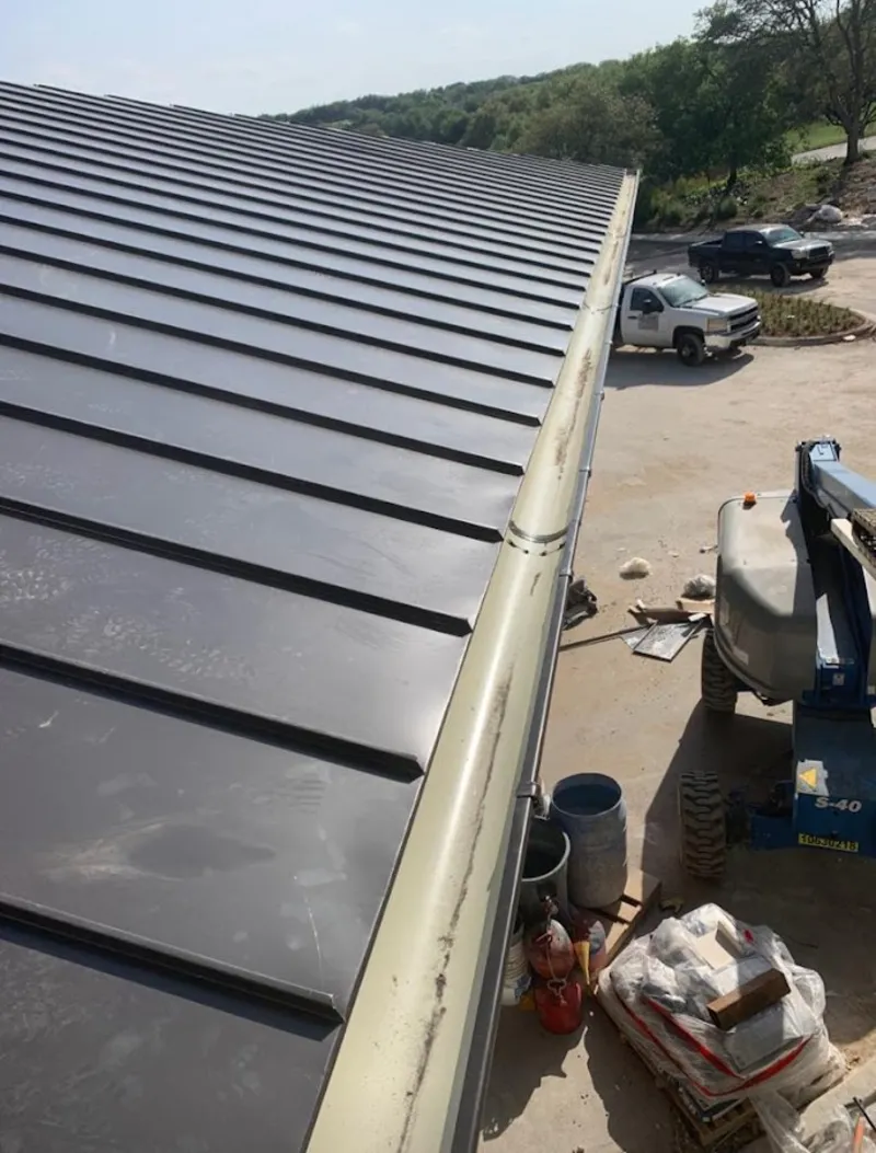 Standing seam panel and gutter detail on a metal roofing jobsite in Bremerton